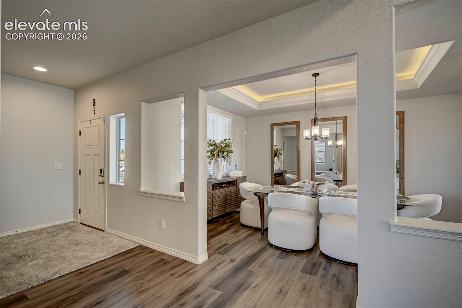 Entryway with wood-finish flooring and a recessed architectural feature