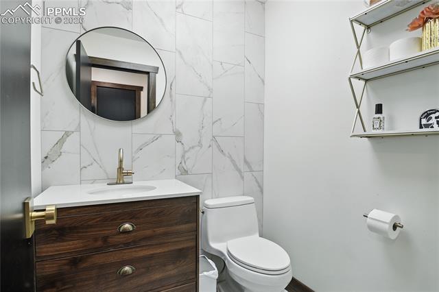 Bathroom featuring vanity and tile walls