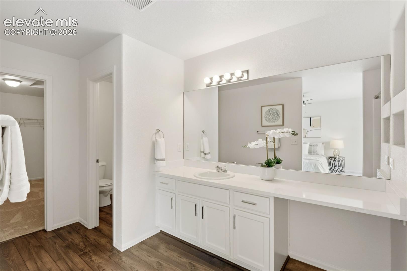Get ready with ease in the primary en-suite bathroom featuring a spacious vanity and stylish ceramic tile