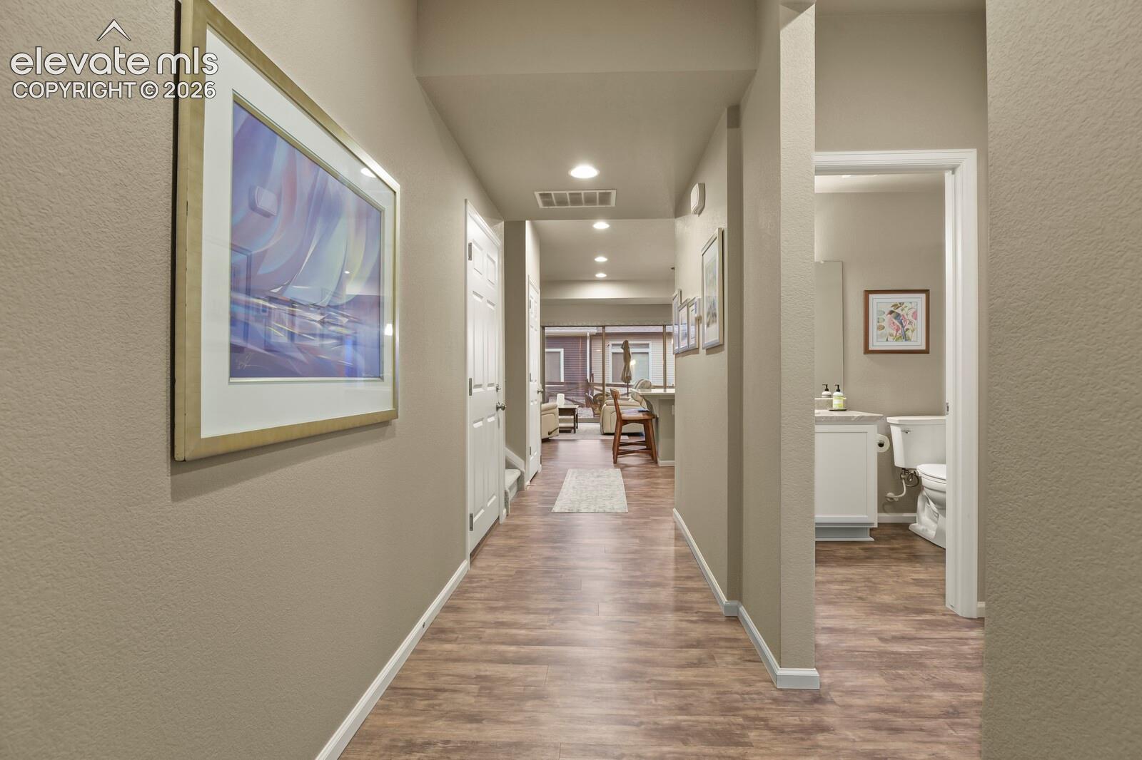 Entry Hallway featuring wood-finish luxury tile flooring, recessed lighting, and a neutral color palette