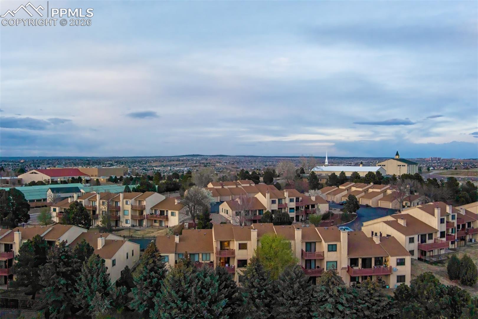 View from above showing the complex and surrounding fir trees.