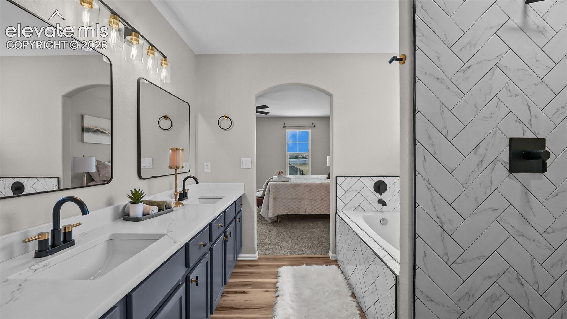 Dual vanity with white countertops, undermount sinks, and matte black fixtures