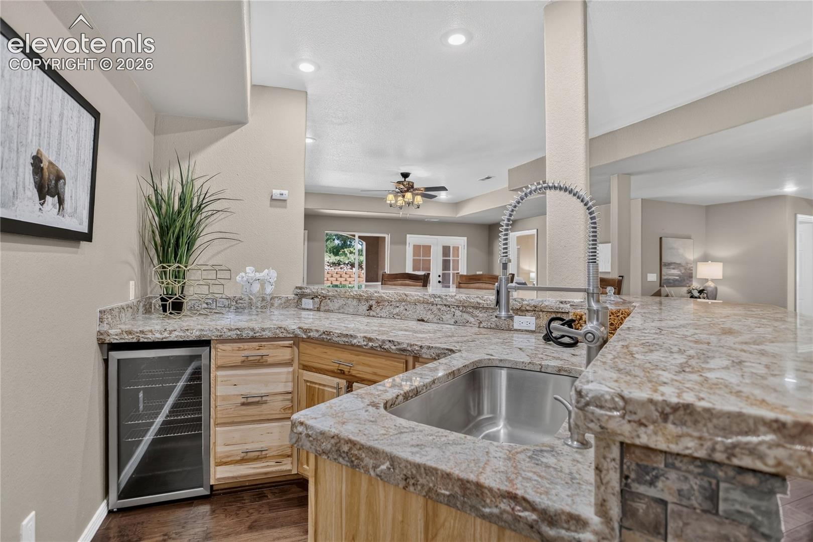 Wet bar comes with chiseled-edge granite counter & beverage fridge
