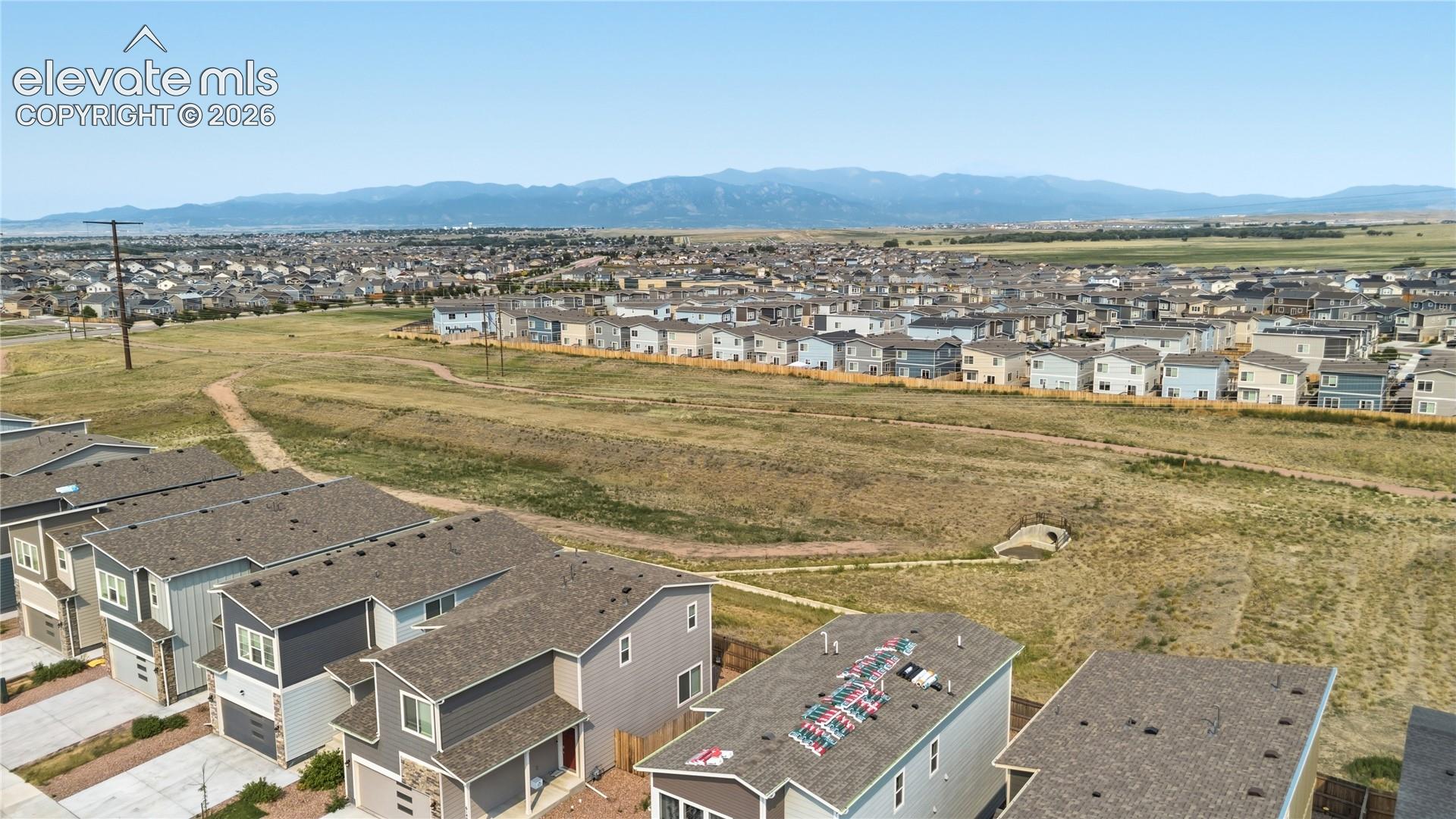 Open space with walking trails and mountain views.