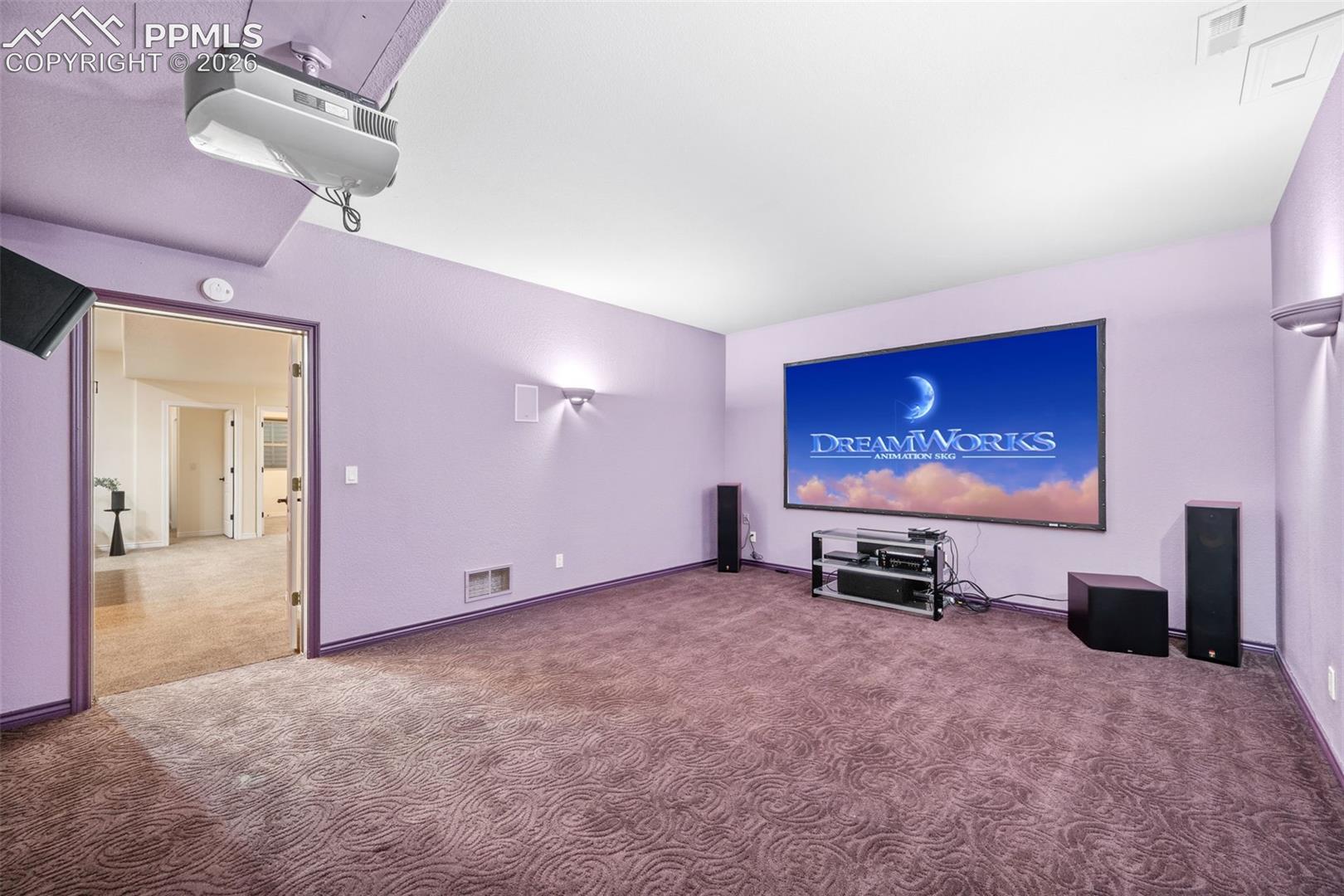 Projector and surround sound speakers produce theater like quality for your movie viewing