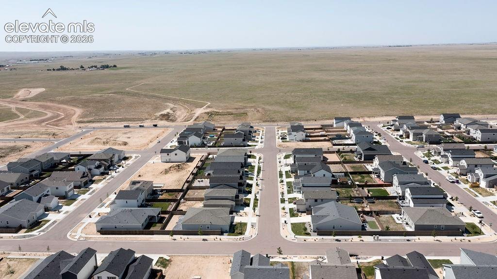 Newly developed residential community featuring a variety of single-family homes with dark shingle roofs and light-colored siding
