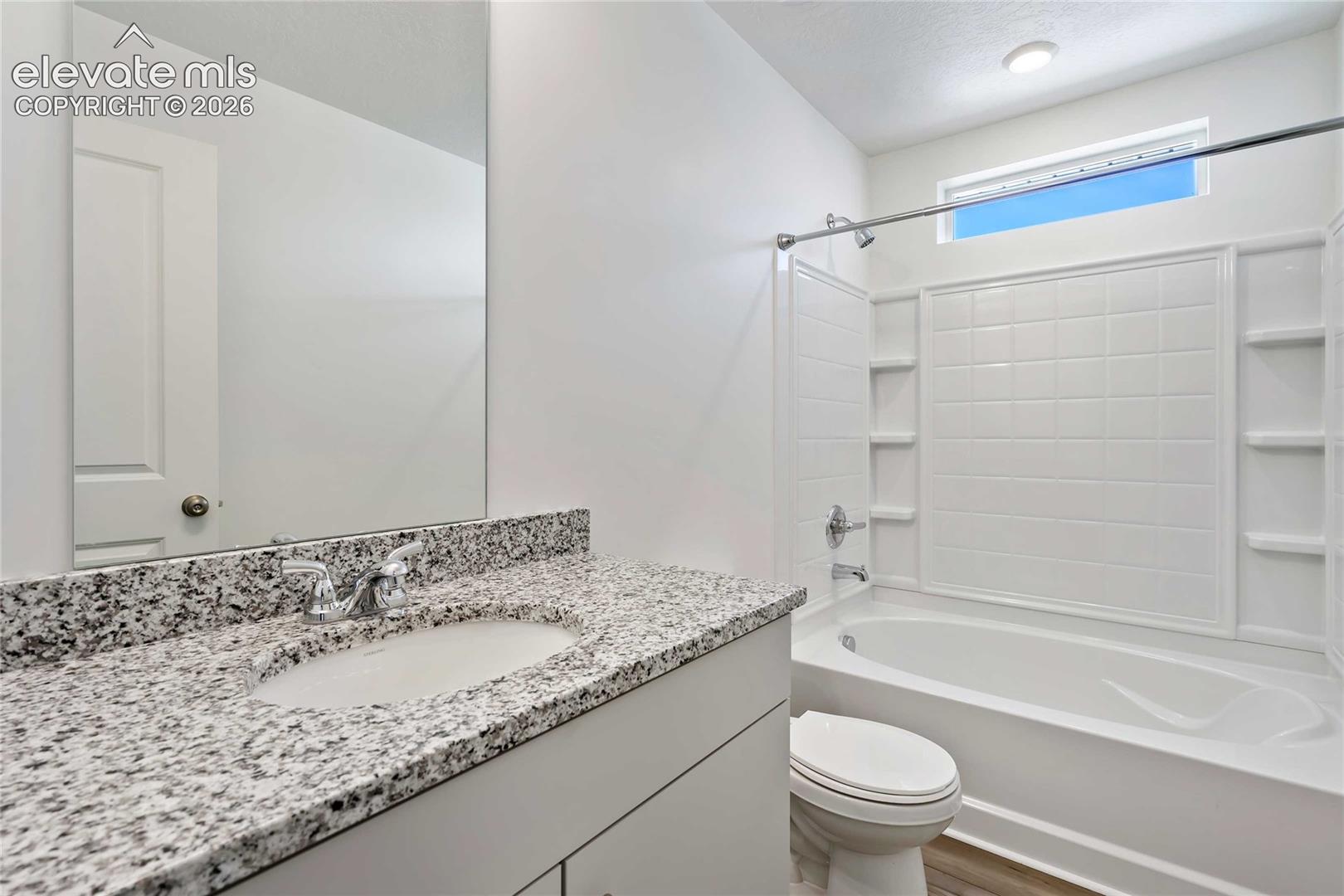 White vanity with granite-finish countertop and integrated sink
*photos of a model home*