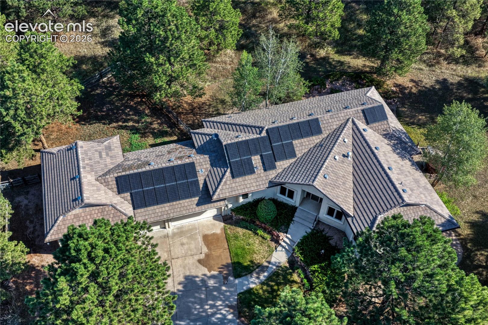 Aerial view showing the paid off solar and concrete tile roof.