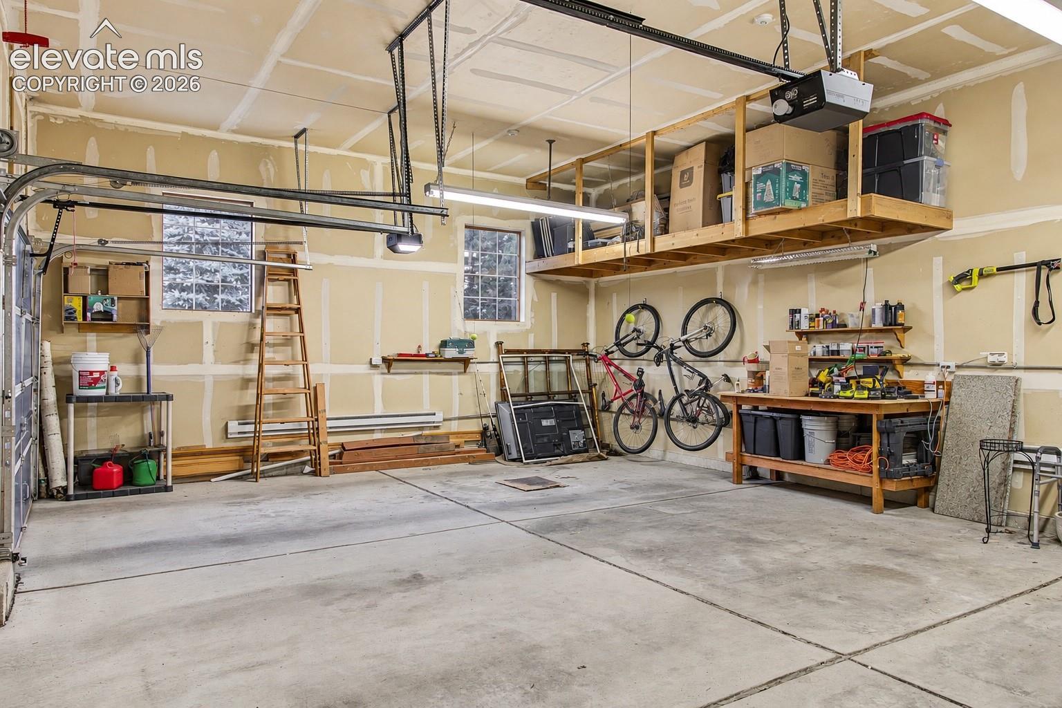 Spacious, attached, heated 3-car garage featuring generous overhead storage space and convenient direct access to the home through the main-level mudroom.