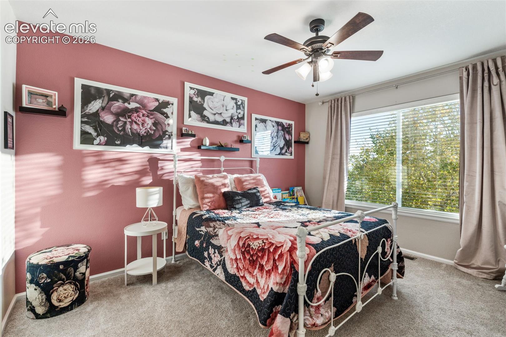 Bedroom featuring carpeting, a ceiling fan with integrated lighting, and a large window with blinds