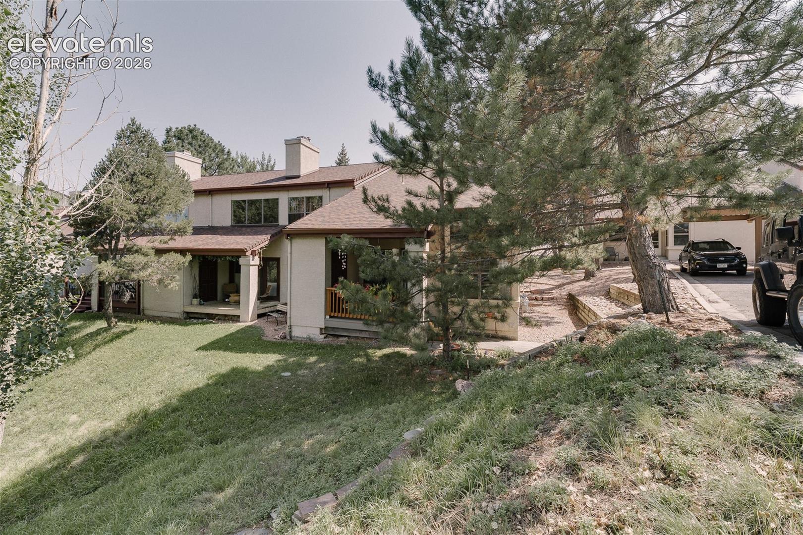 Surrounded by towering pines and backing to serene open space.