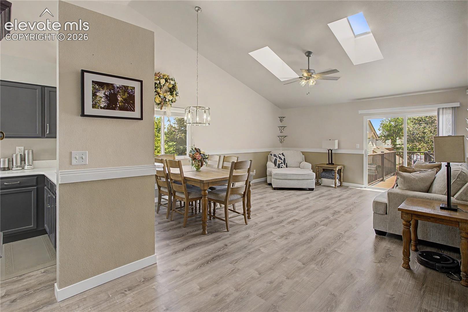 Open dining and living with skylights