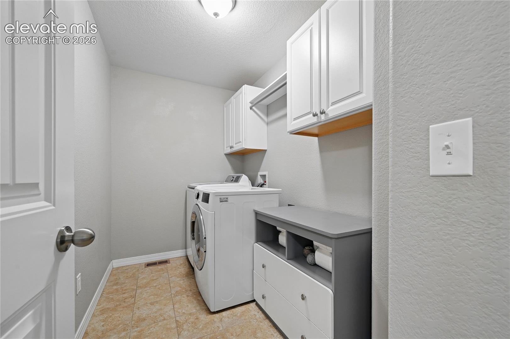 The laundry room is upstairs, and has extra space for folding & storing things, rather than cluttering a hallway by the garage.