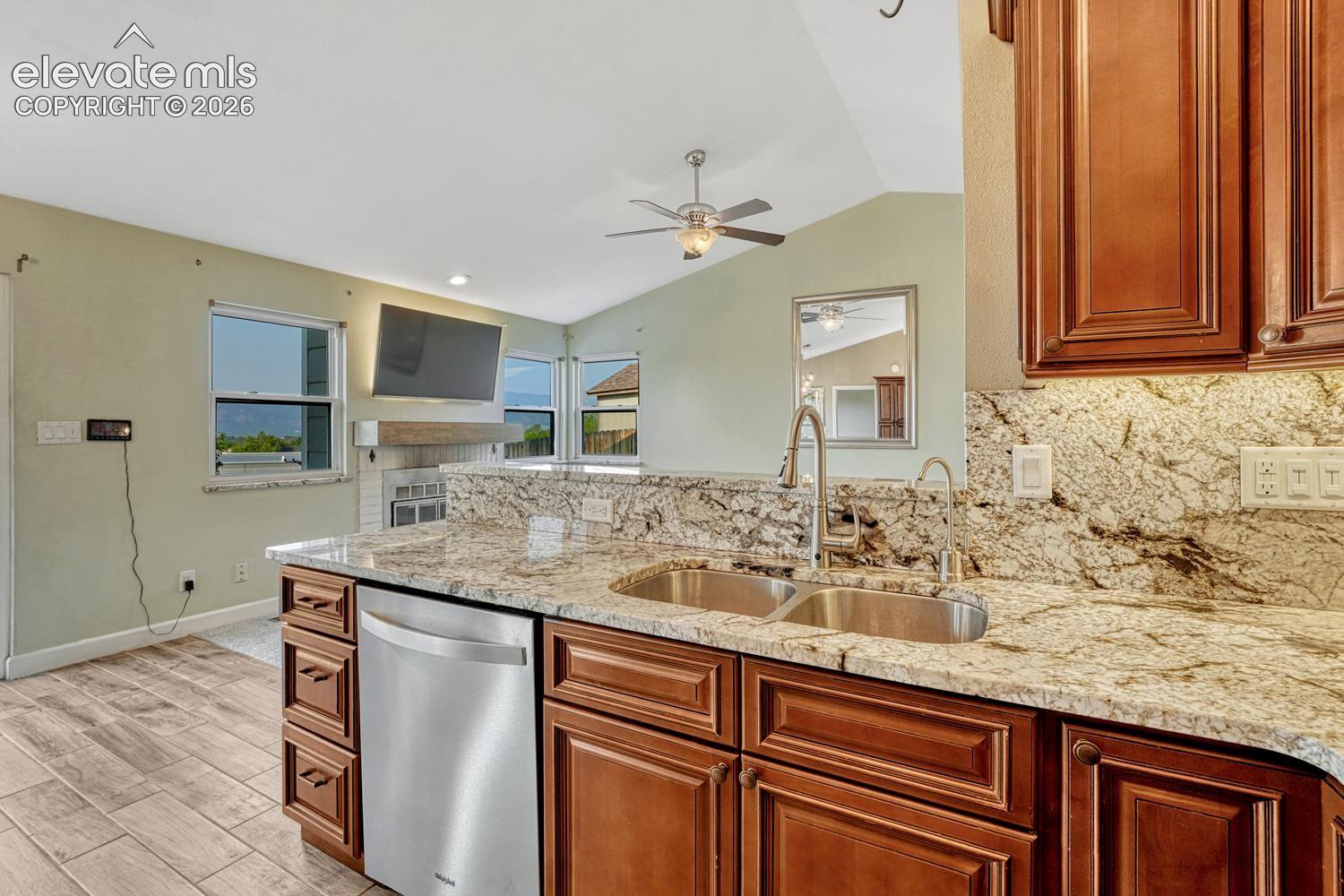 Kitchen with granite counter and cherry cabinets