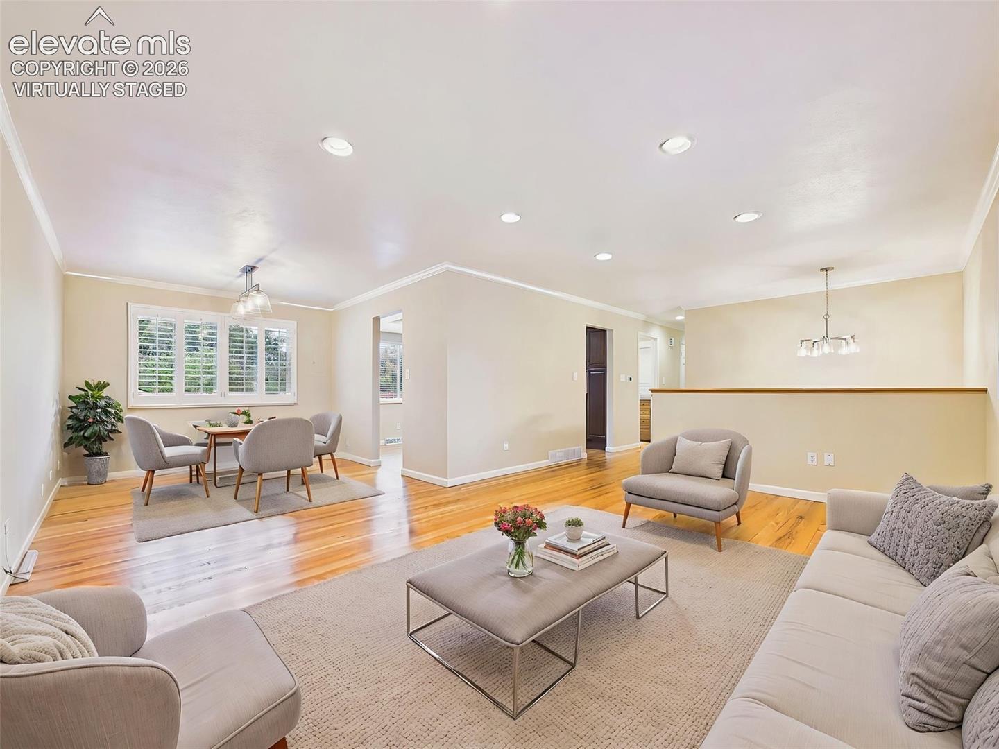 (Virtually Staged) Living & Dining Areas – Open-concept living and dining spaces provide an ideal setting for everyday living and entertaining, accented by refinished hardwood floors and abundant natural light.