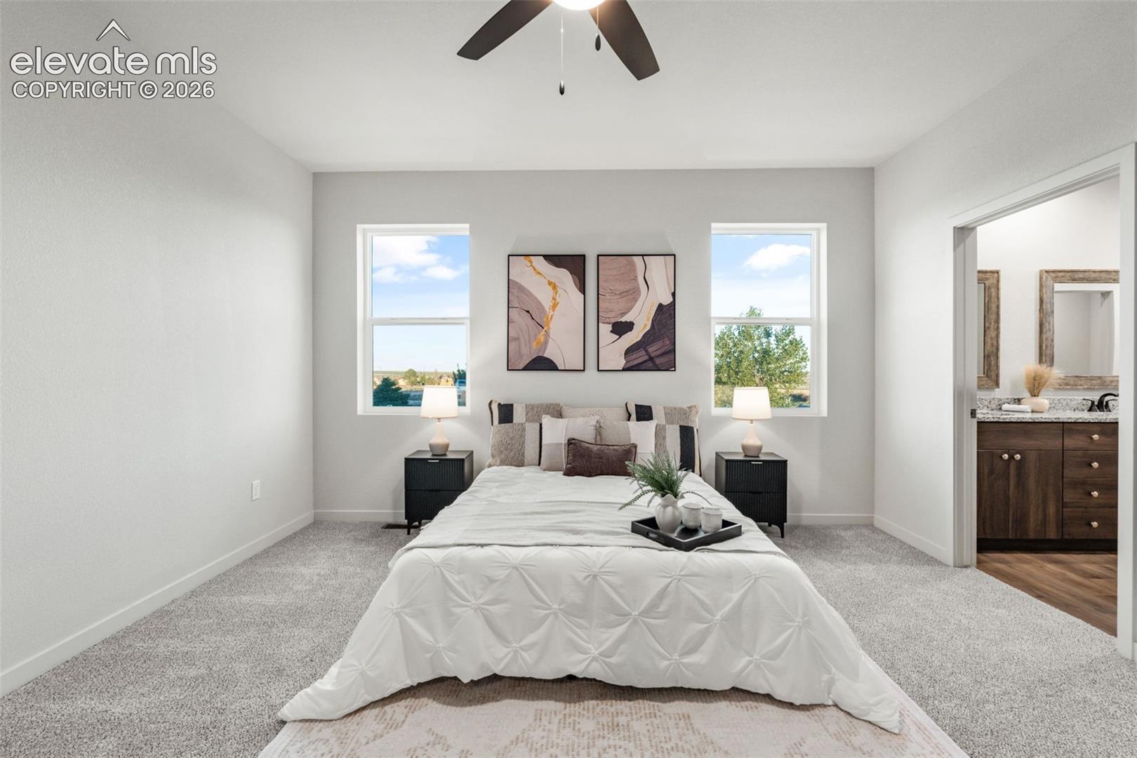 Bedroom featuring plush wall-to-wall carpeting, dual windows with natural light, and a centrally mounted ceiling fan