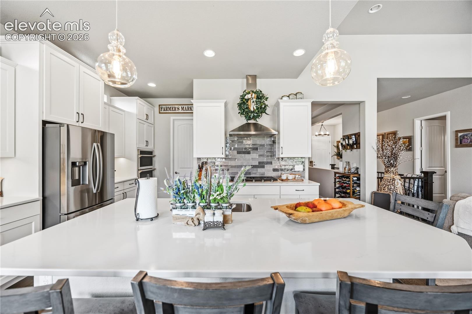 THE HEART OF THE HOME — An expansive island takes center stage in this sophisticated open-concept kitchen, effortlessly blending everyday function with elevated style.