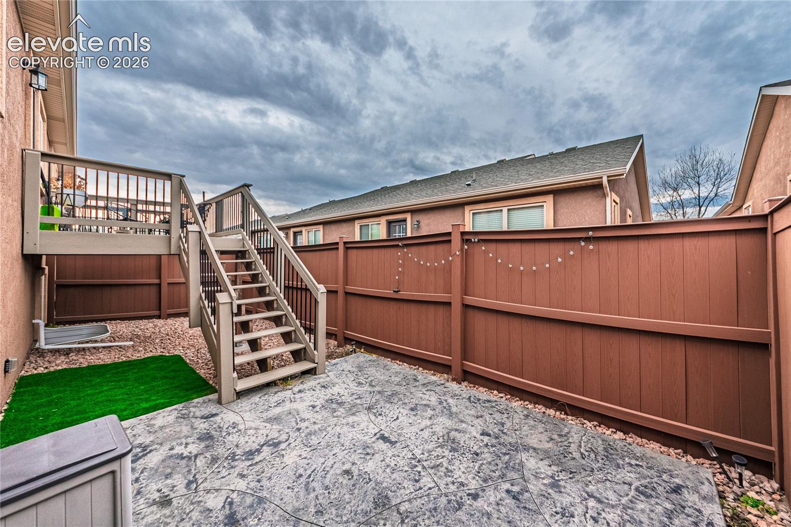 Fenced backyard with a deck and stairway