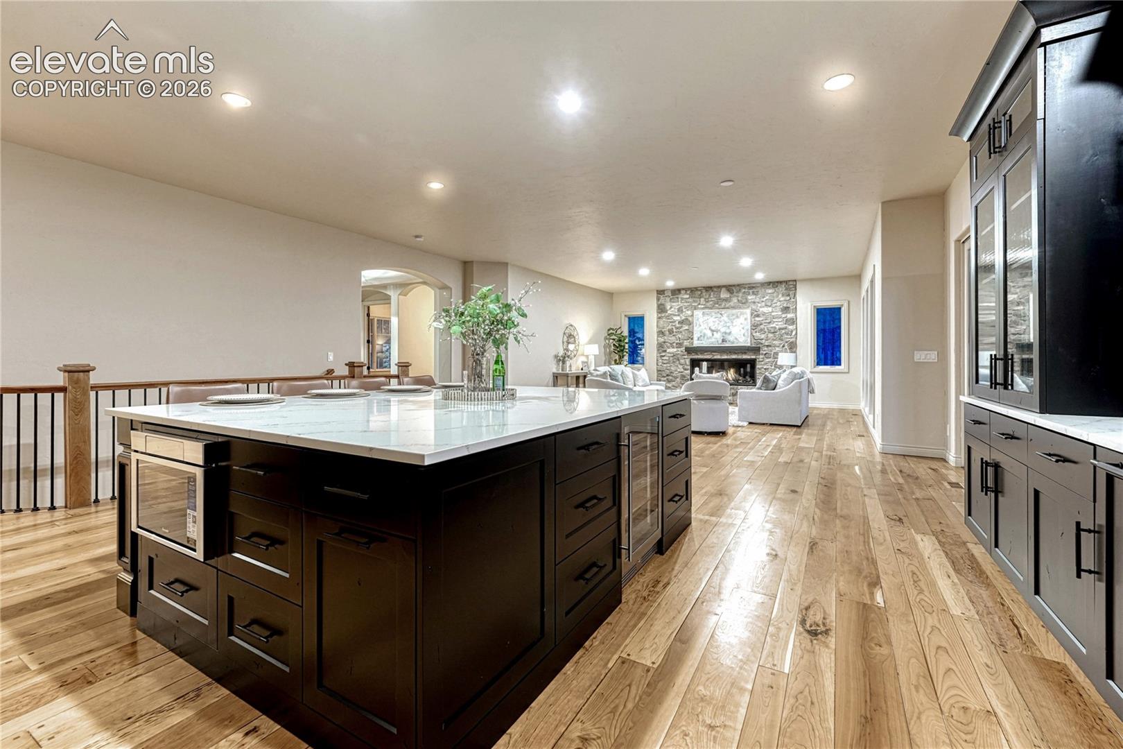Featuring a large quartz island and breakfast bar. 