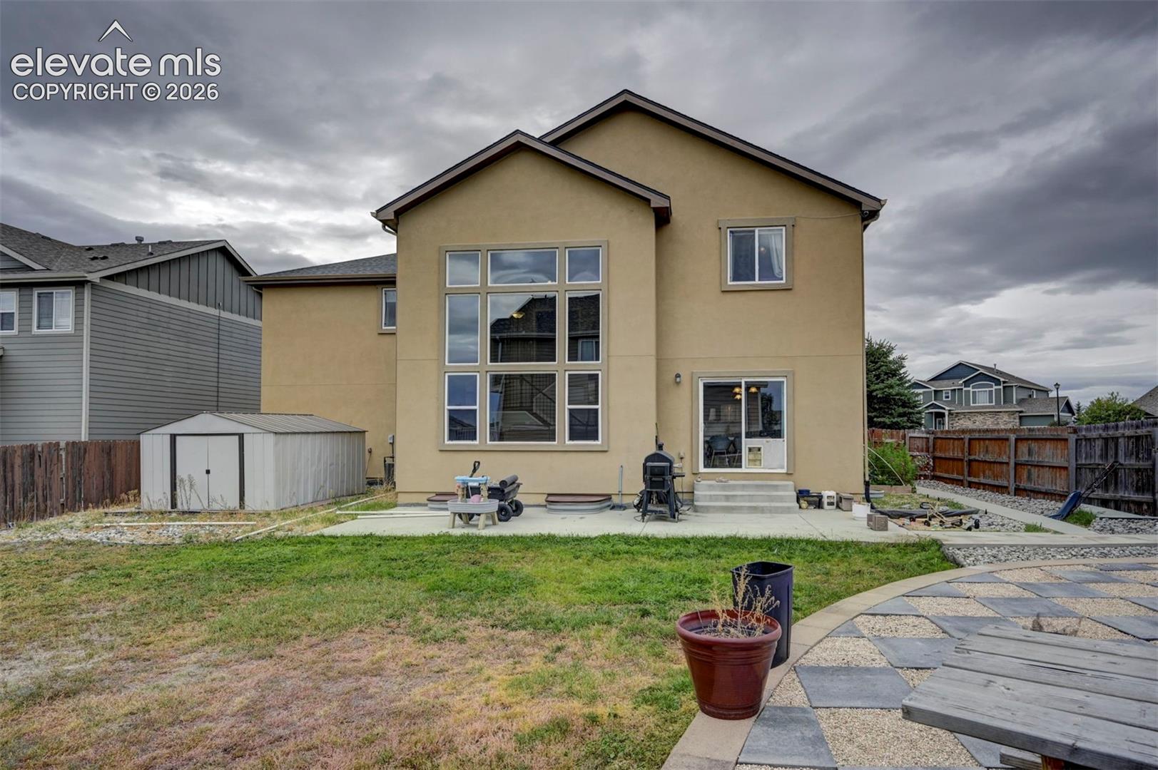 Back of the home and storage shed