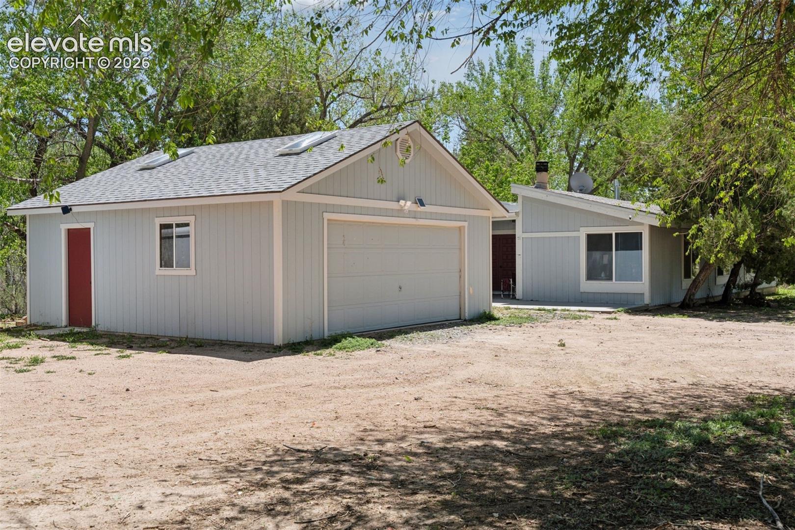 Exterior view of the 5-bedroom, 2.5-bath single-family residence with detached two-car garage (16885 Old Pueblo Rd)