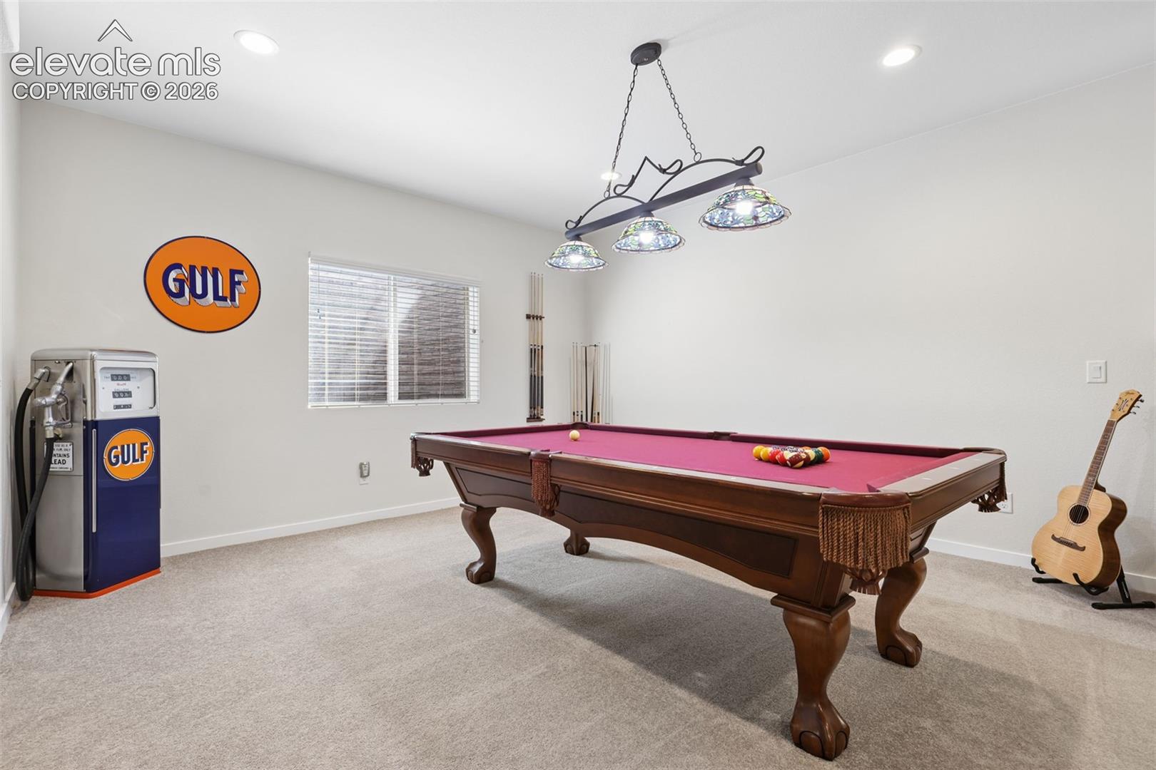 Recessed ceiling lighting, a window with blinds, and a chandelier with decorative shades