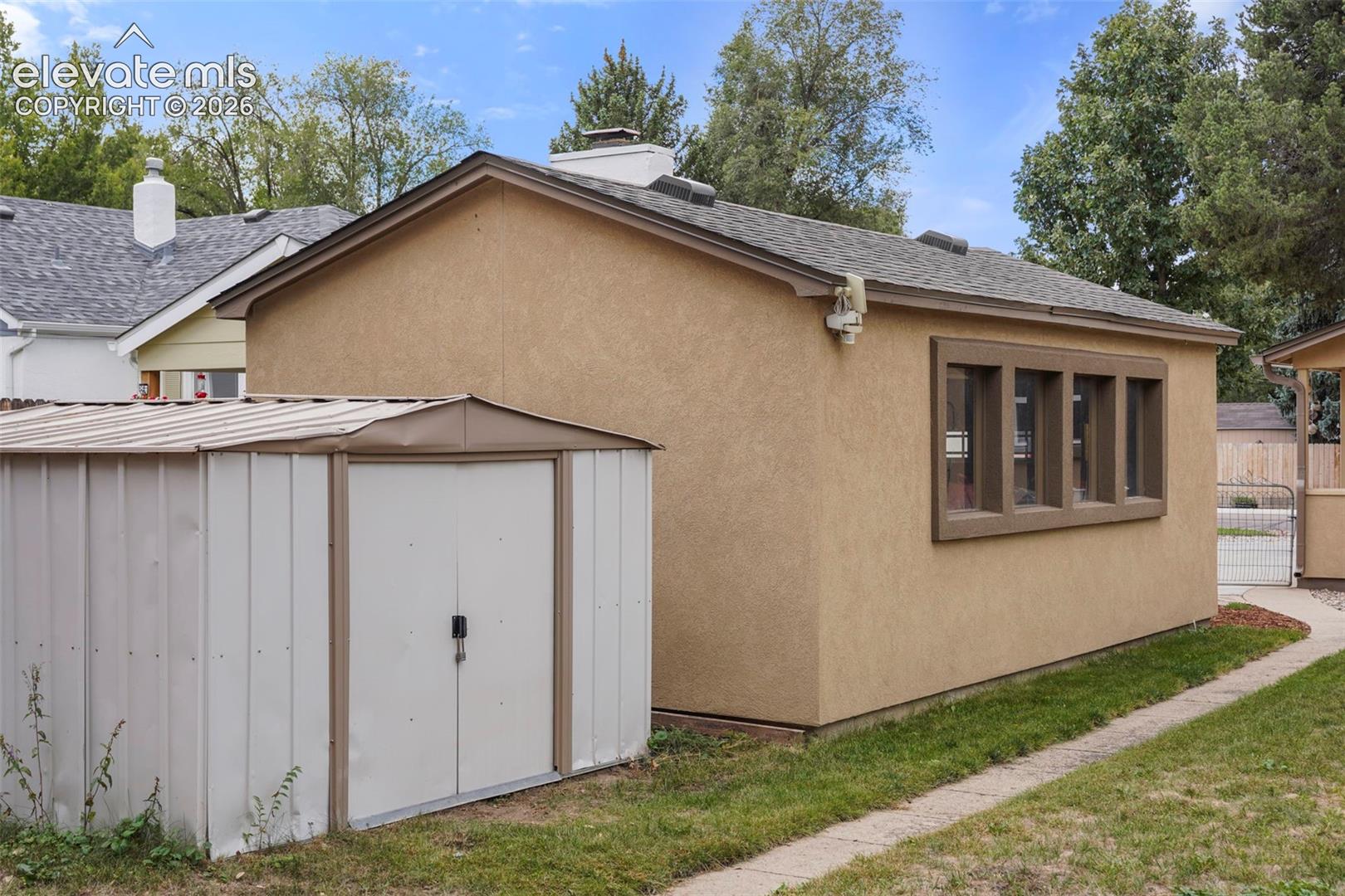 Oversize garage with windows and storage shed