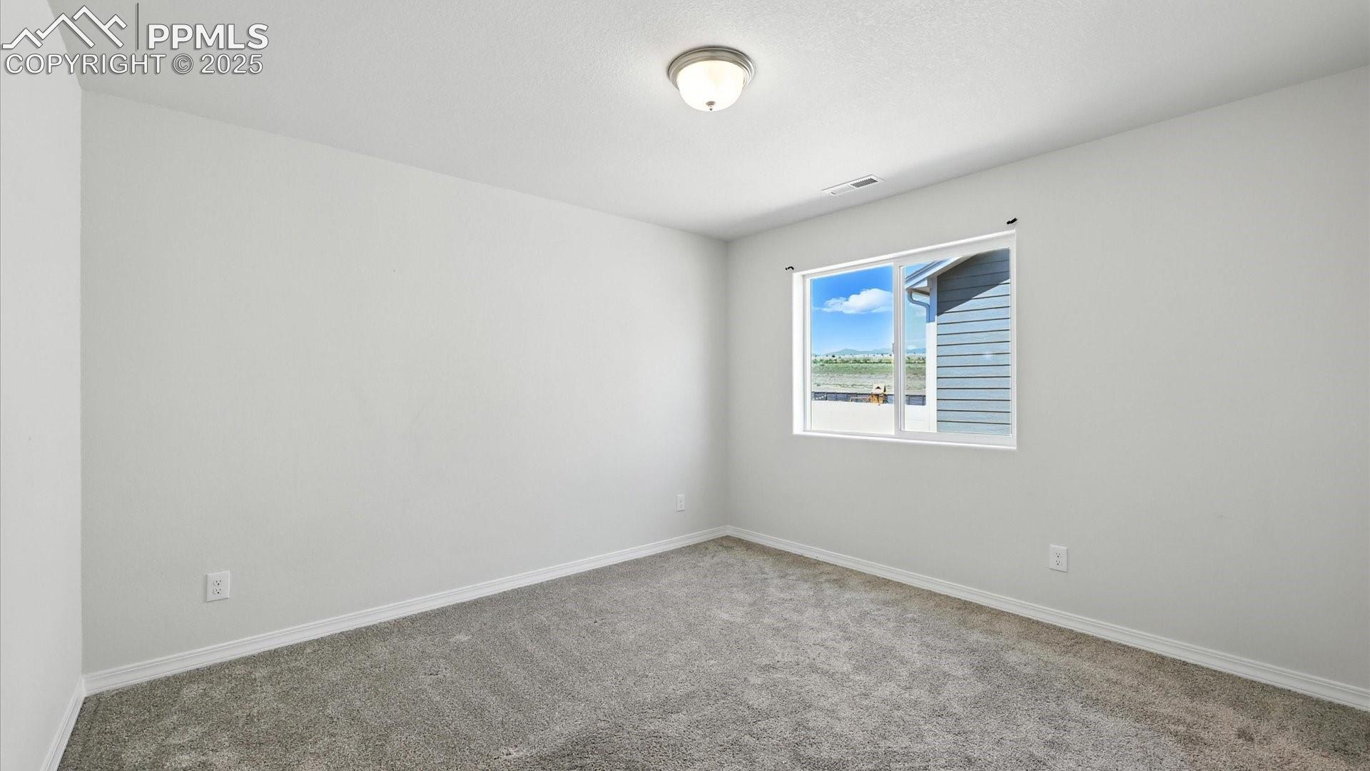 Upper Level Bedroom #3 with neutral carpet.