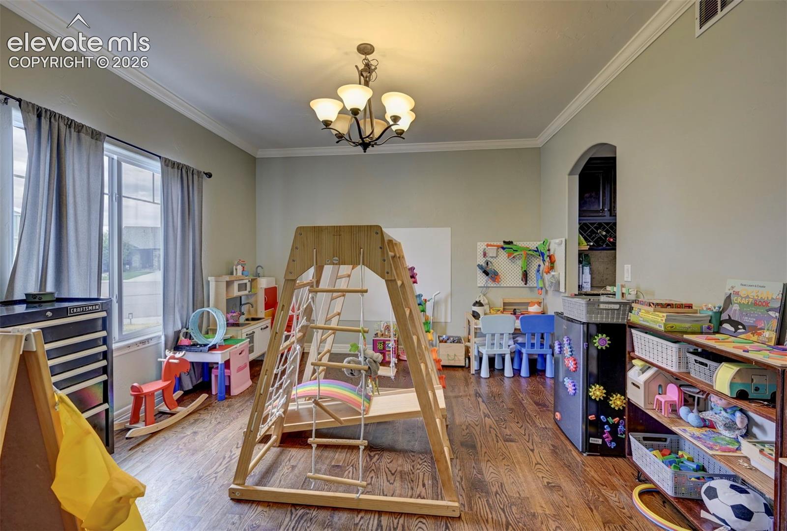 Formal dining room with hardwood floors and crown molding