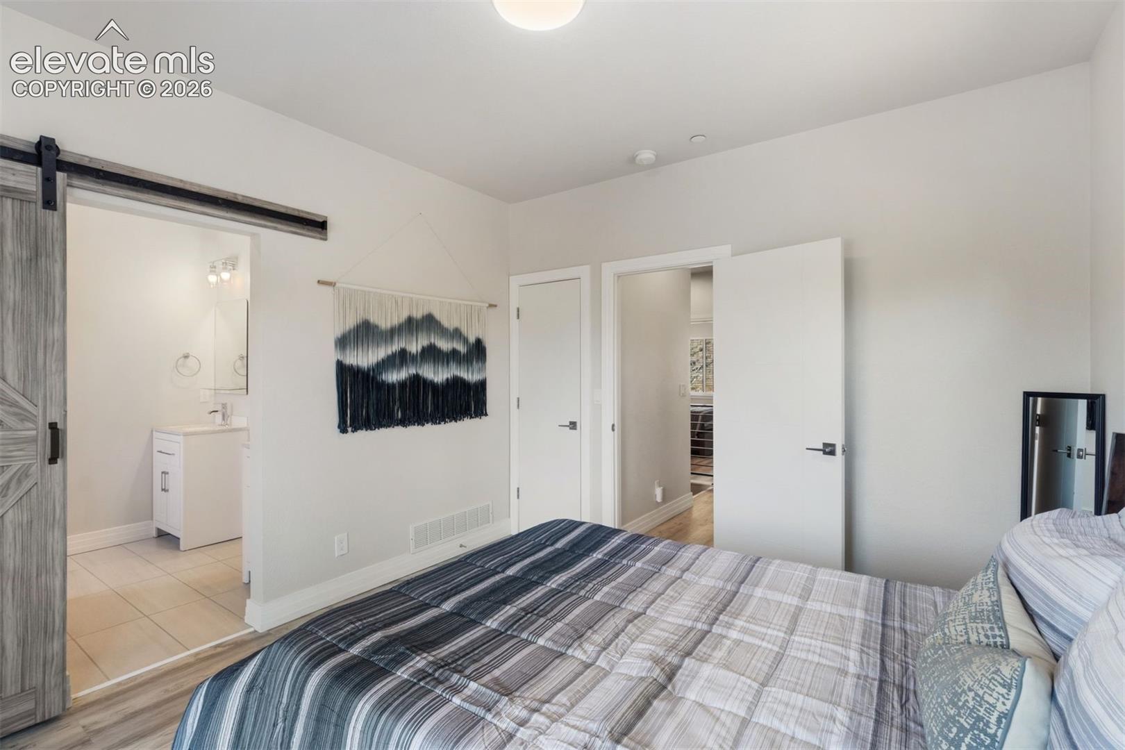 Primary bedroom with ensuite bath, walk in closet, and private deck access to roof top