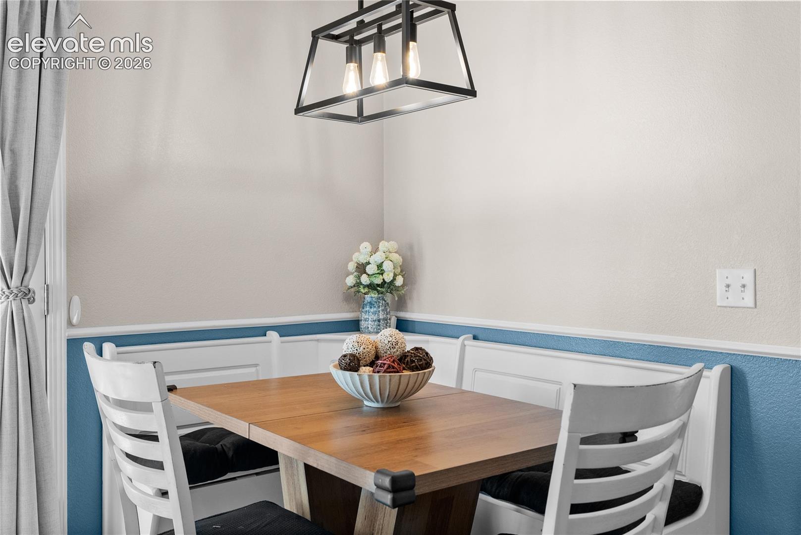 Built-in corner bench seating with wainscoting detail