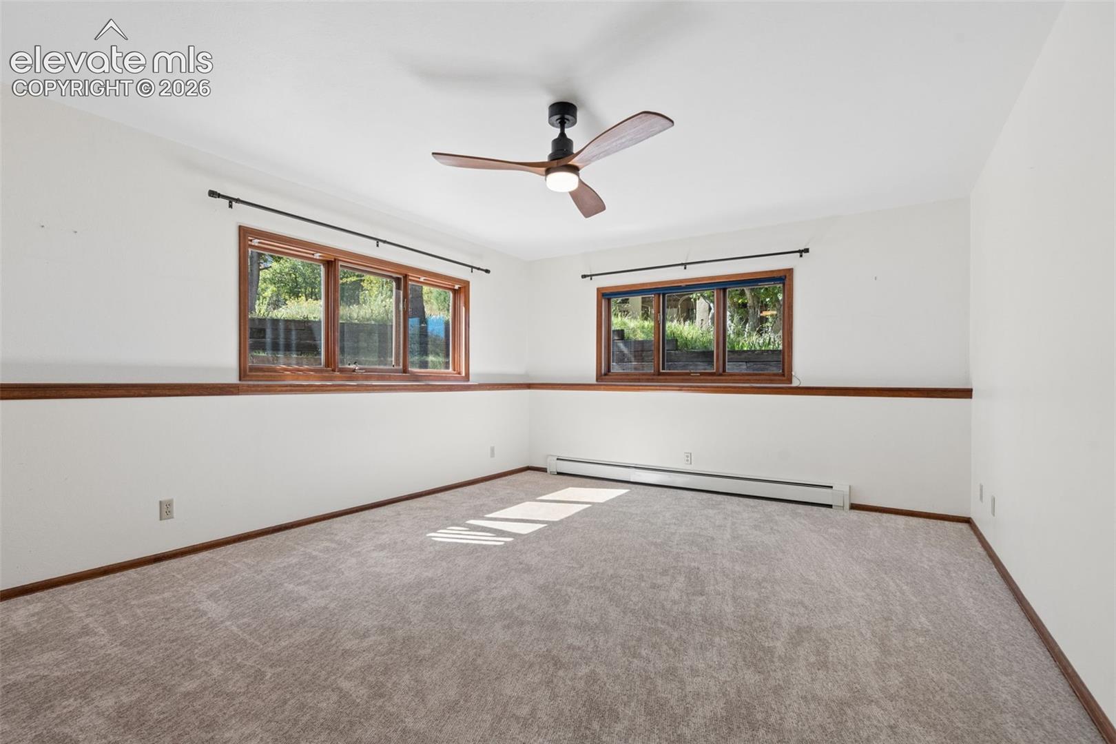 Carpeted interior with wood trim and white walls