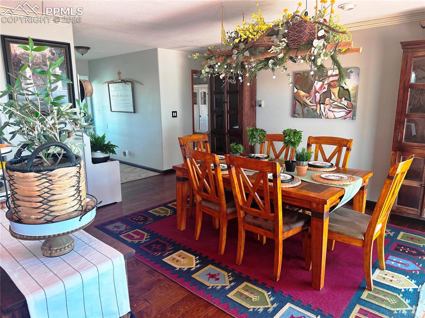 Dining room with entry from outside and hallway to primary bedroom, guest bedroom and bathrooms at top.

