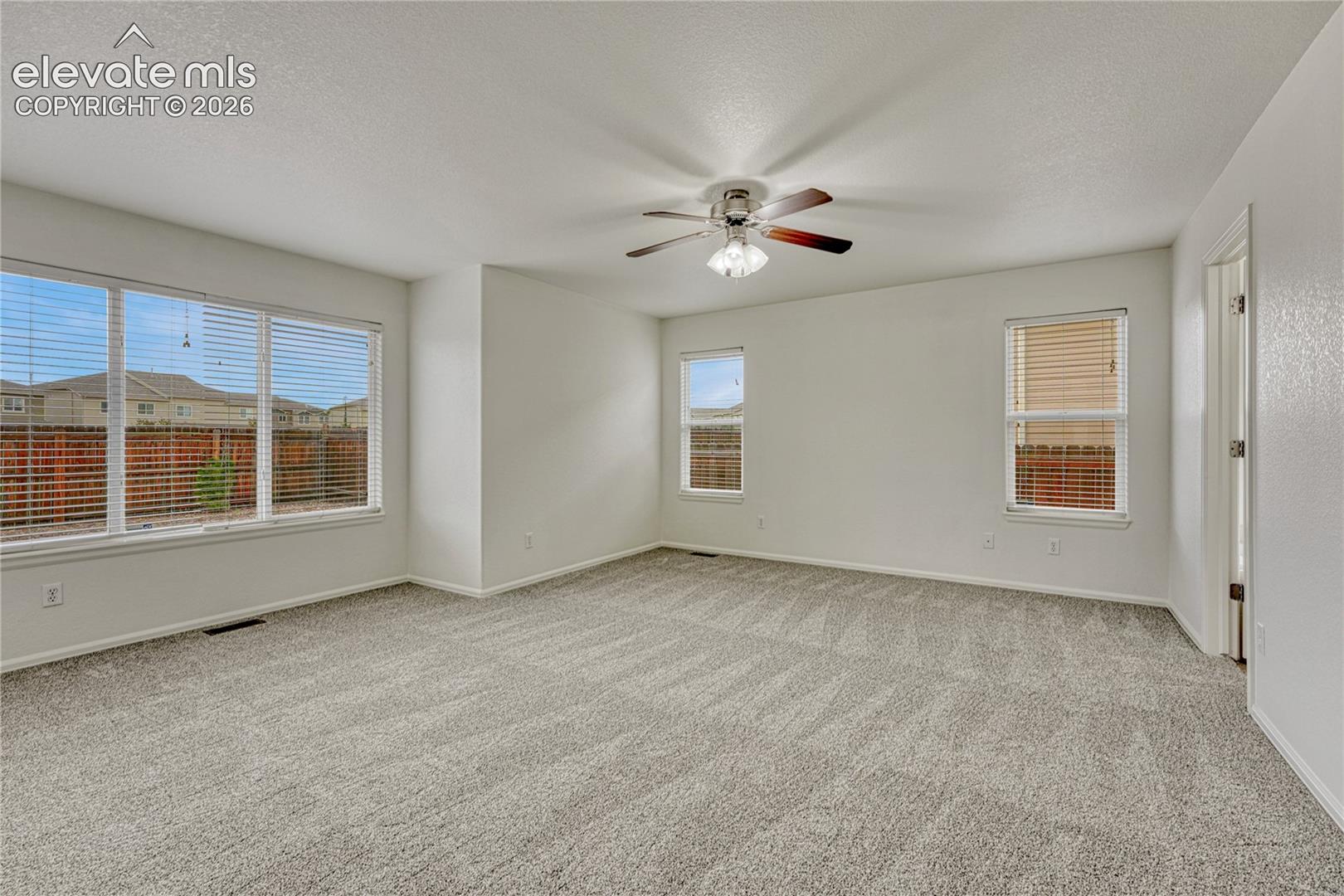 Main level primary bedroom is light and bright. 