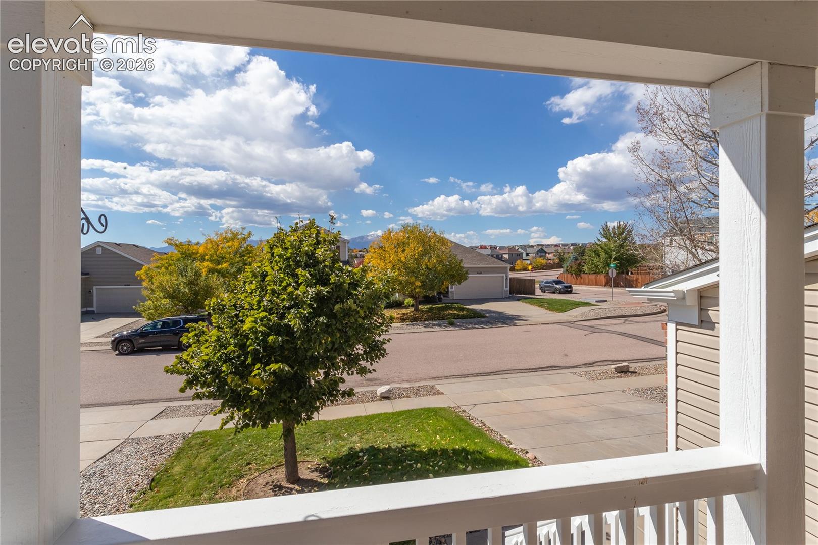 Looking out from the front porch reveals scenic mountain outlines and peaceful neighborhood surroundings