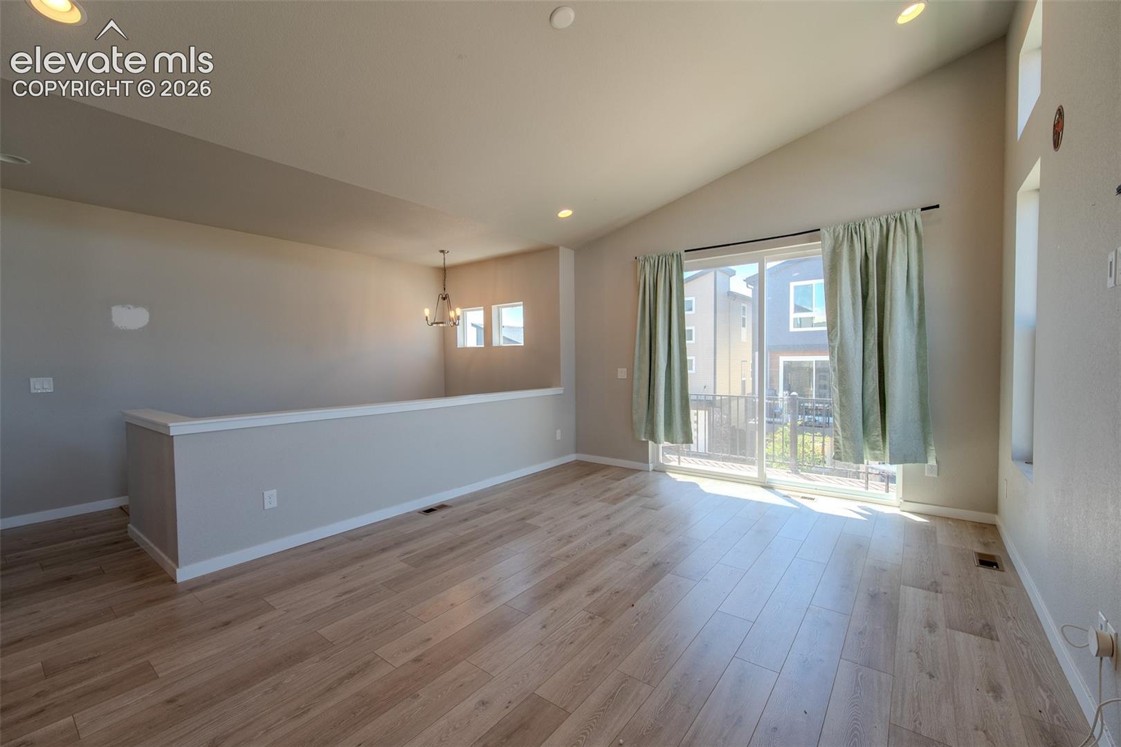 Upper Level Living Room with sliding door to a composite balcony.