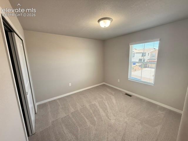 Neutral-toned walls complement the light-colored carpet flooring