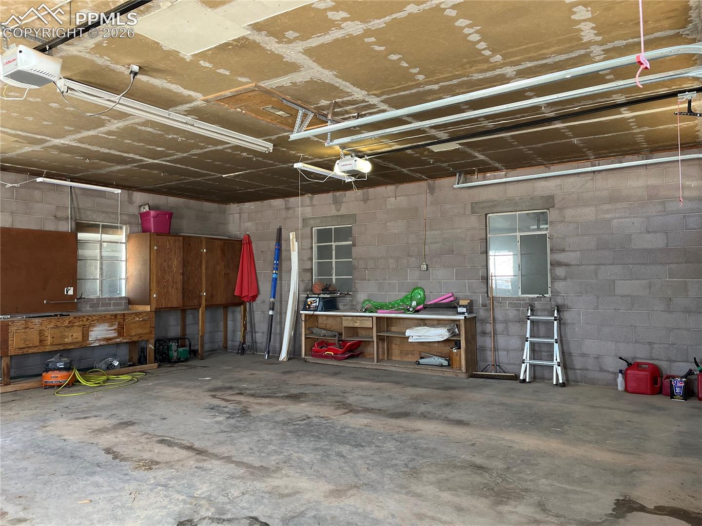 Garage with concrete block wall and a garage door opener
