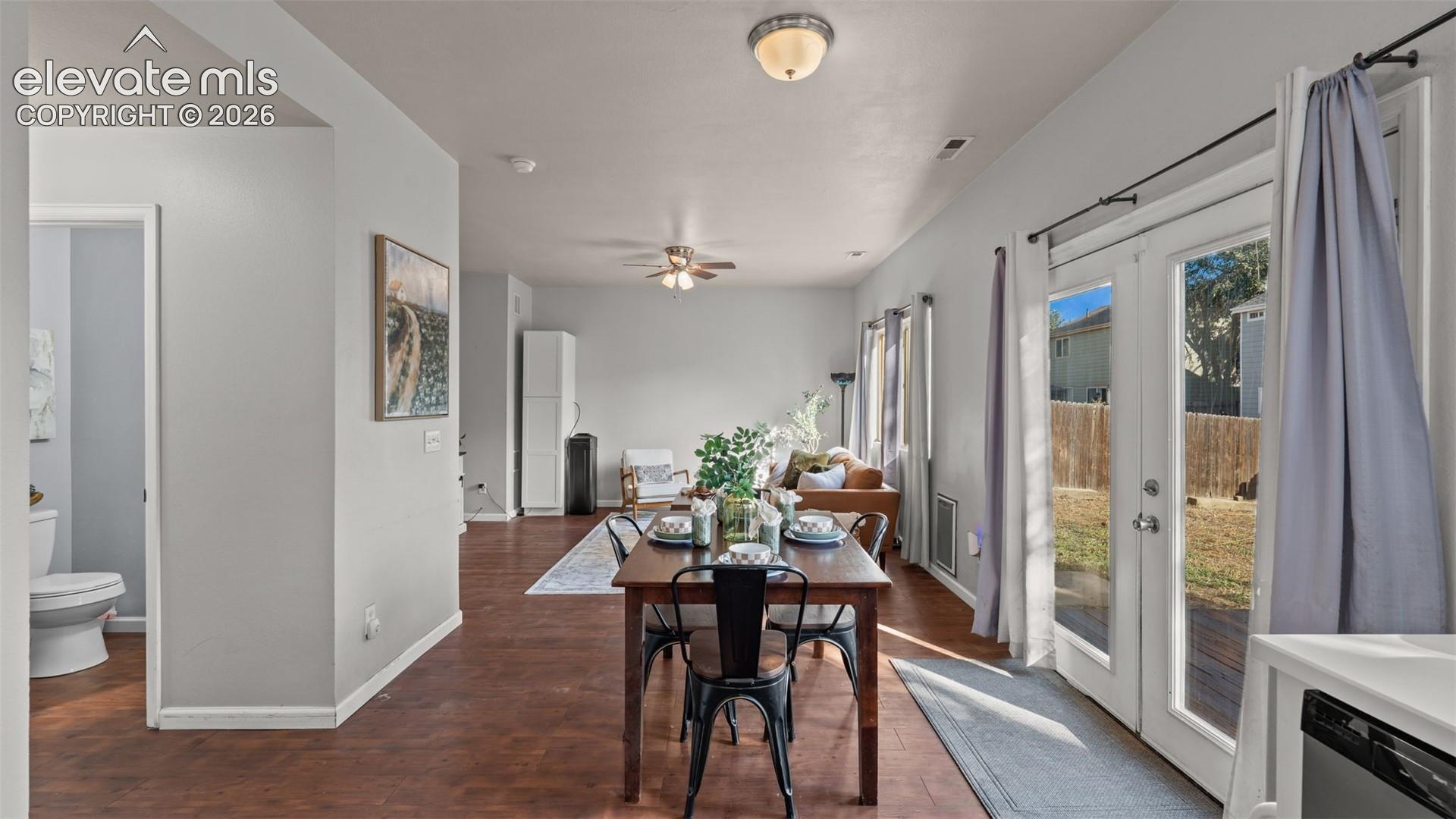 Open-concept living area with wood-finish flooring, recessed lighting, and ceiling fan