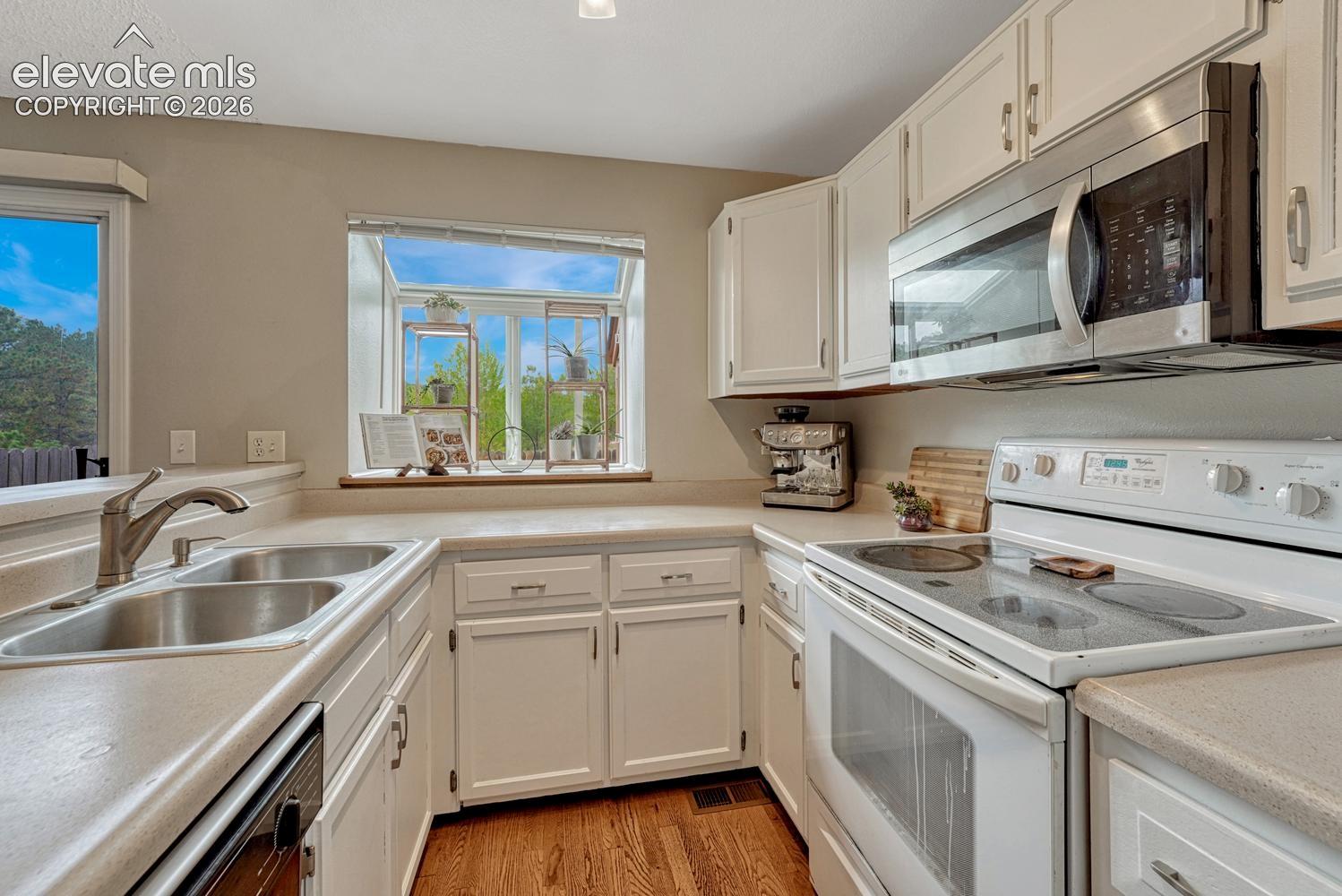 Refrigerator, range oven, microwave, and dishwasher included
