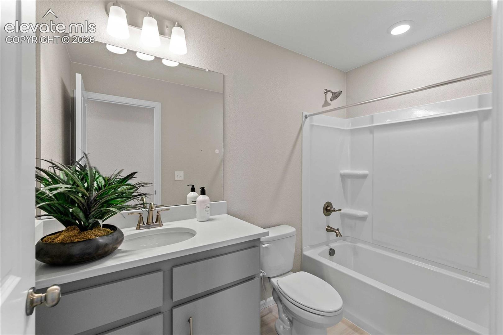 Single vanity with a light-toned countertop, undermount sink, and brushed nickel faucet
*photos of a model home*