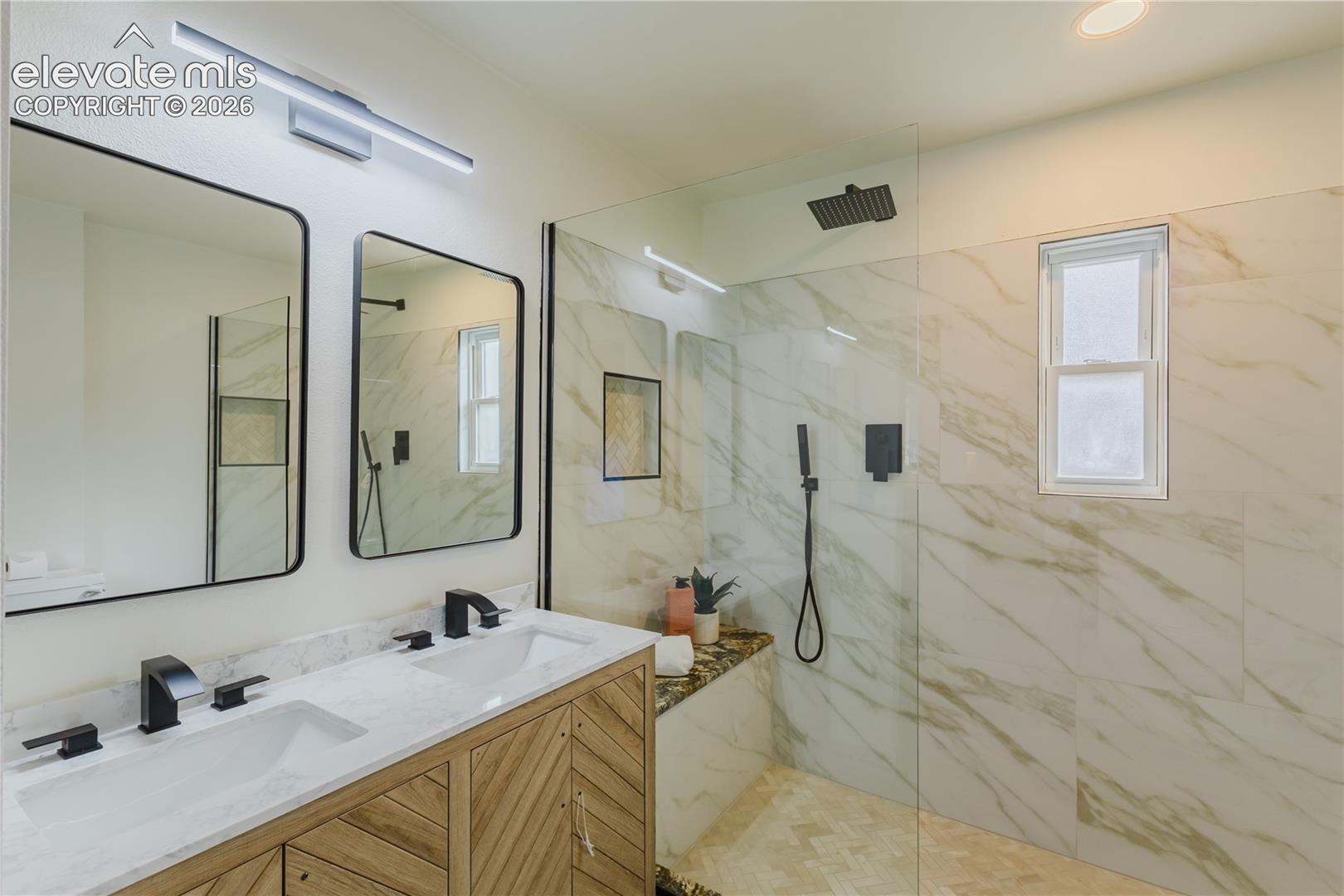 Dual vanity with matte black fixtures and a white countertop