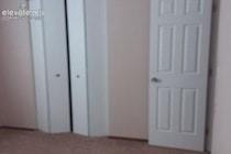 Six-panel interior door with brushed nickel hardware and dual-panel bifold closet doors