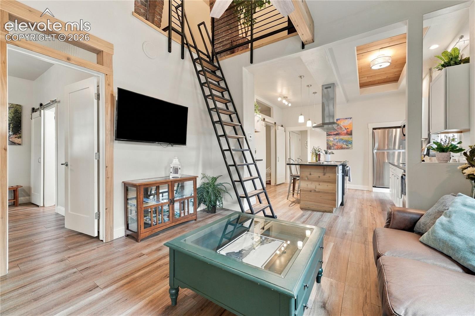 Step inside to the light and bright open floorplan. First Bedroom Suite is shown to left. Ladder leads to the bonus loft area.