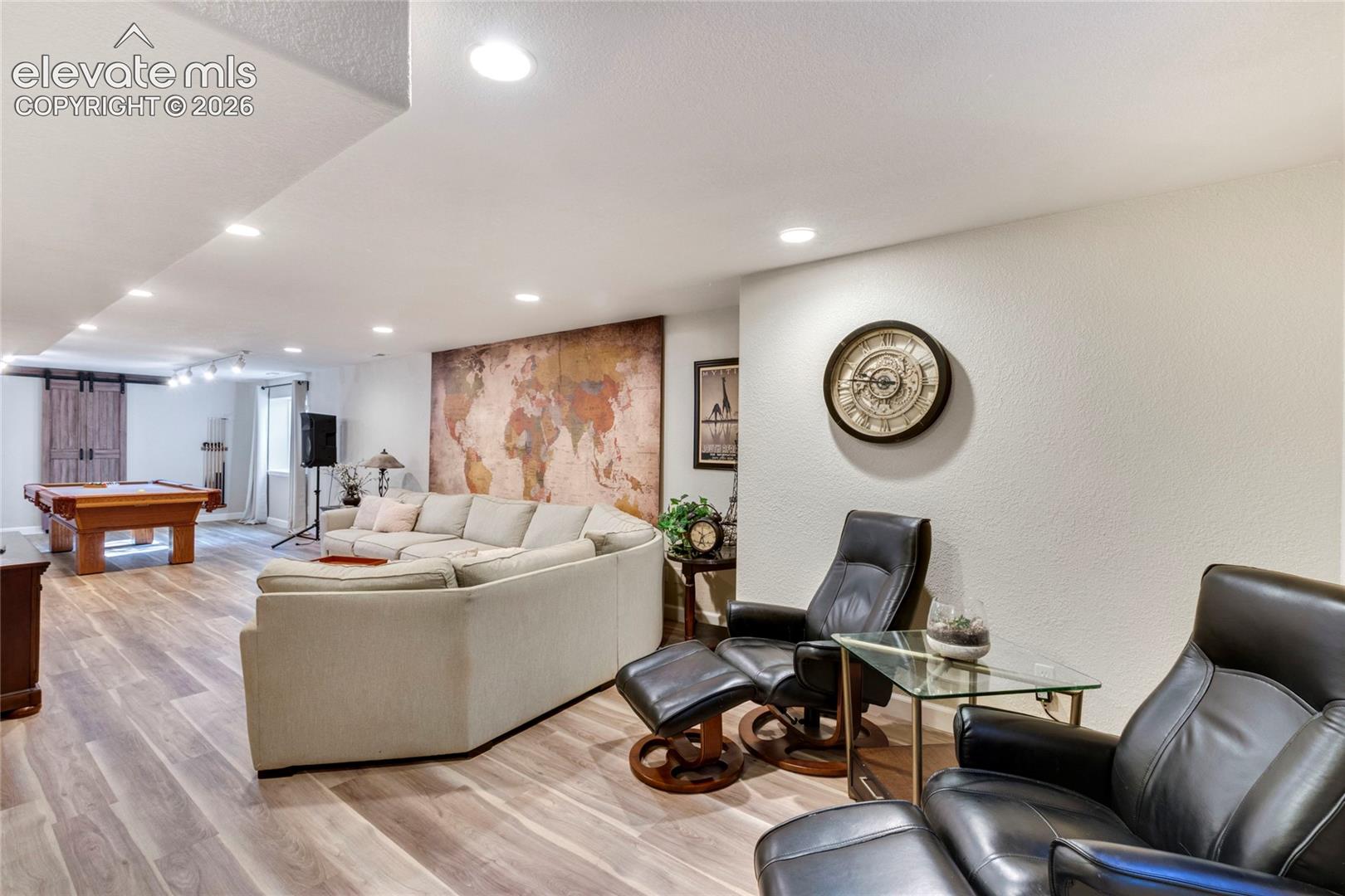 Open-concept interior featuring wood-finish flooring and recessed lighting throughout