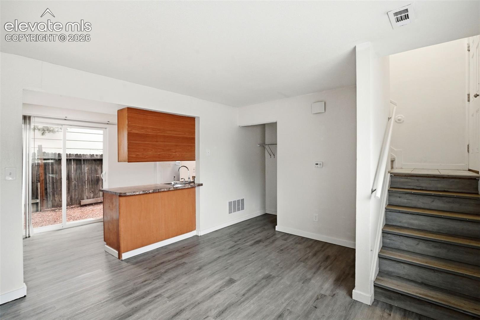 Stairs to the Front Door and Access to the Kitchen from the Living Room