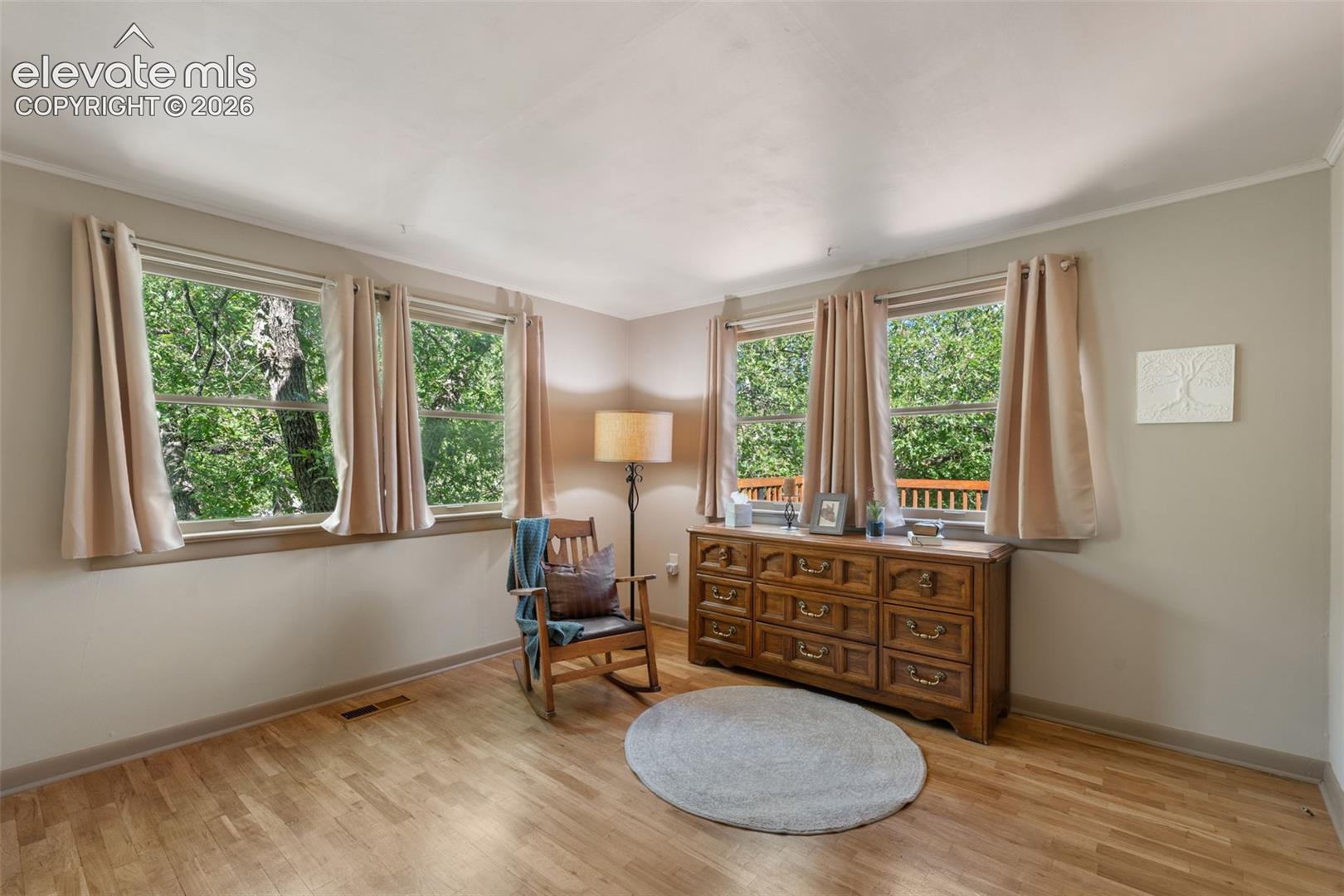 Hardwood-finish flooring extending throughout the room