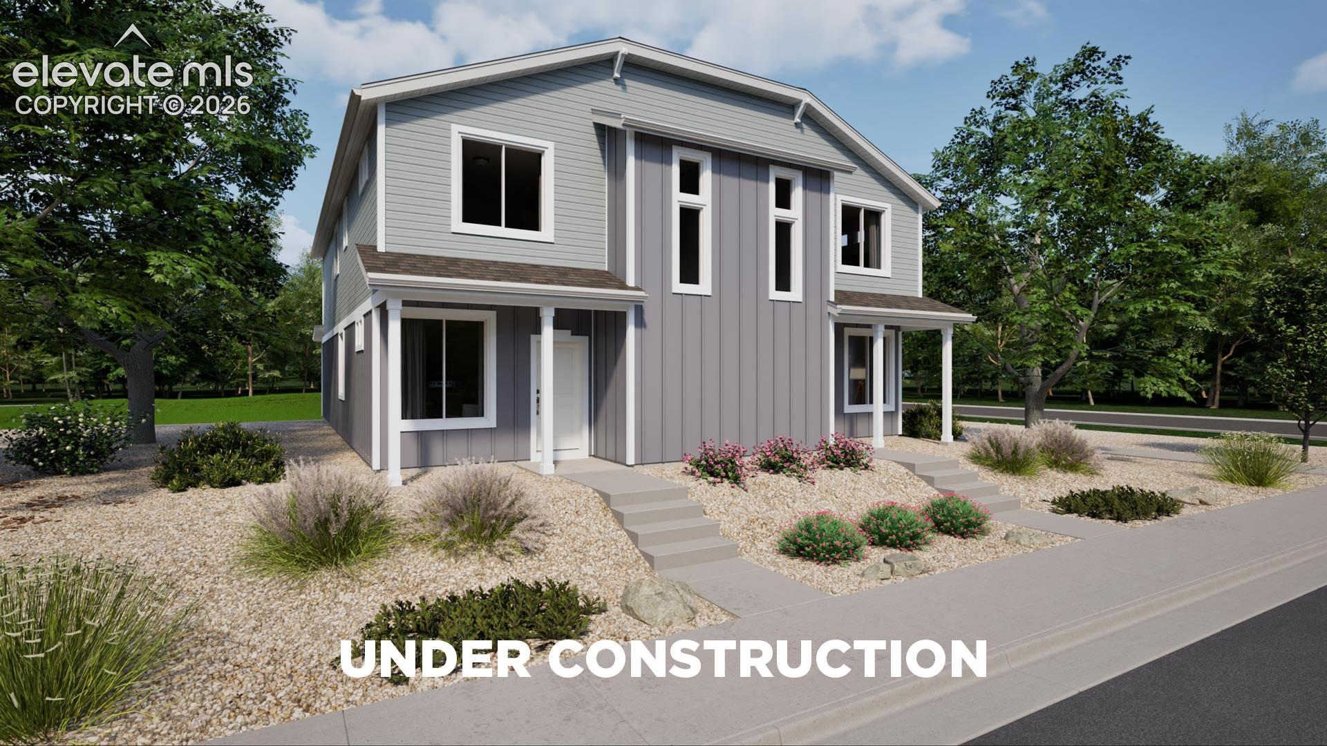 Two-story exterior featuring a mix of horizontal lap siding and vertical board-and-batten siding, dual covered entry porches, concrete entry steps, and rock-based landscaping