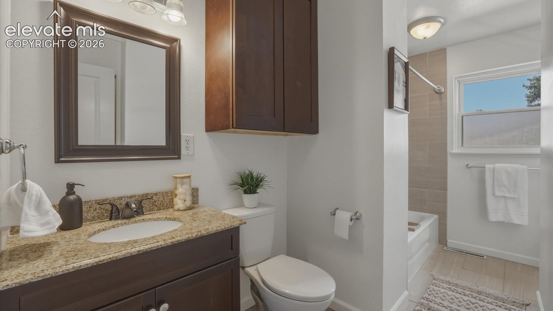 The Upper Level Full Bathroom features a granite vanity, framed mirror, storage cabinet, and tiled tub/shower.
