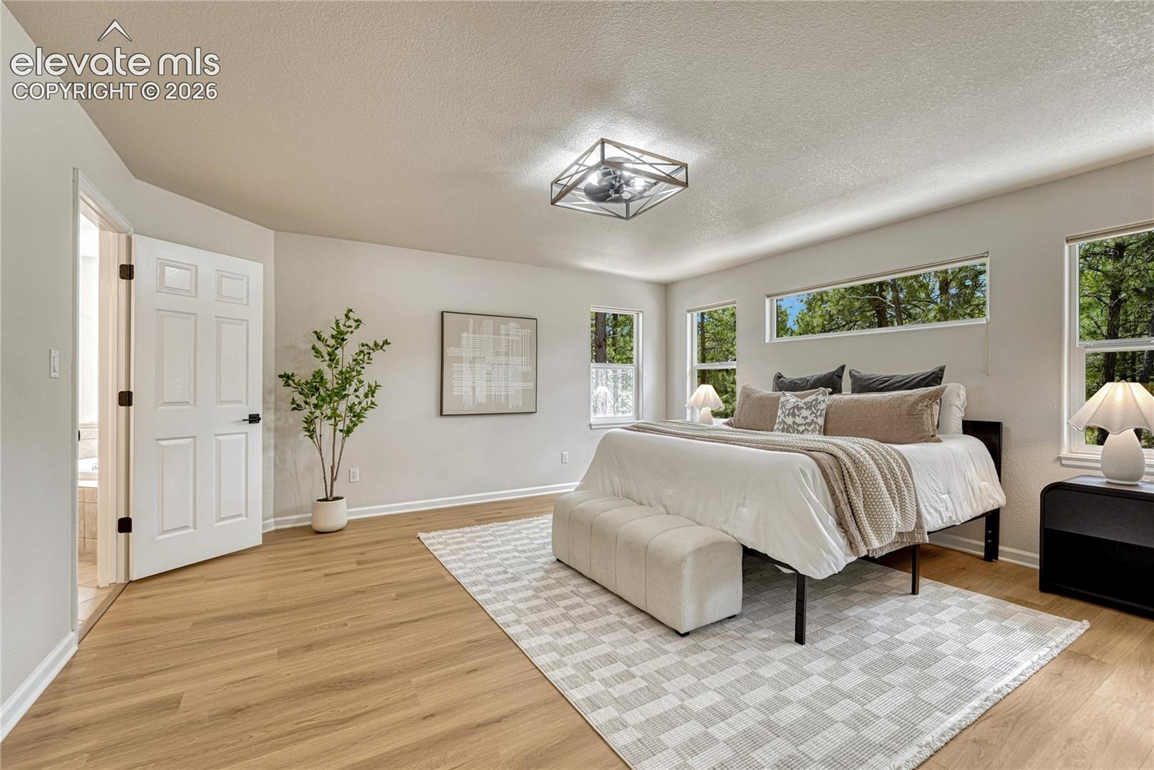 Enter the primary bedroom through double doors. 